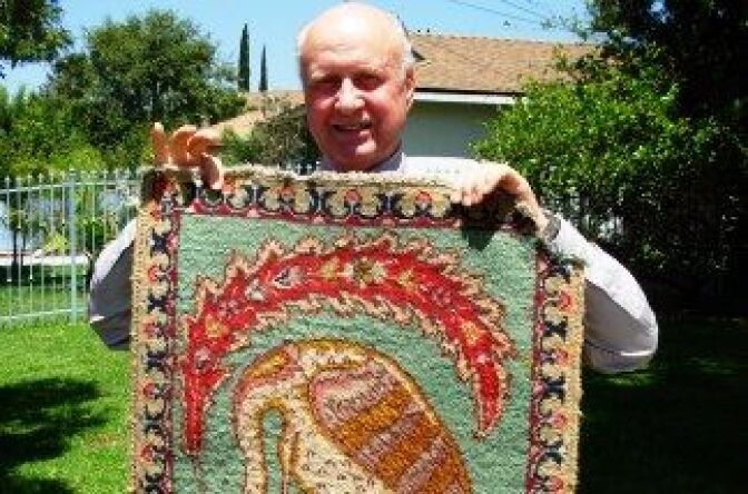 Charles Perry displays a rug given to him by the late Owsley Stanley.