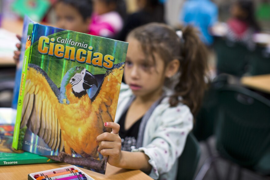 First grader Elizabeth Gatlardo reads a Spanish-language science textbook at George Brown Elementary, a dual-language school in San Bernardino, on Monday morning, May 4, 2015. The Common Core standards come with suggested English-language texts that illustrate the concepts which students need to learn for each standard. Former principal Lorraine Perez says she is not convinced that translating English-language texts would help students’ learning in Spanish.