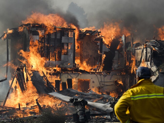 A wildfire consumes a home Tuesday, Dec. 5, 2017, in Ventura. Raked by ferocious Santa Ana winds, explosive wildfires northwest of Los Angeles and in the city's foothills burned a psychiatric hospital and scores of homes Tuesday and forced the evacuation of tens of thousands of people.