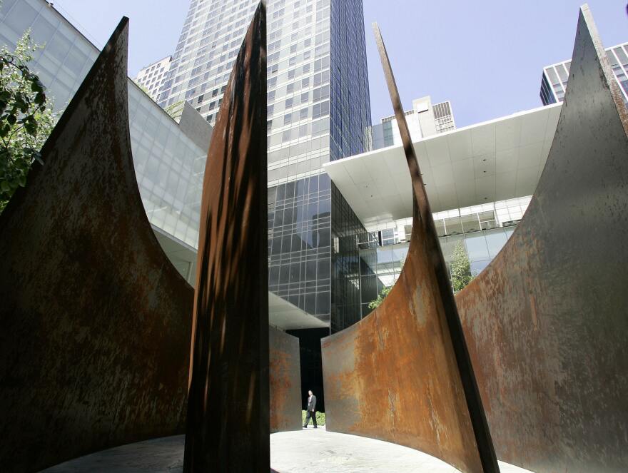 Members of the press walk through the sculpture titled "Intersection II" by Richard Serra during the press preview May 29, 2007 at the Museum of Modern Art, "Richard Serra Sculpture: Forty Years".