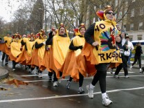 In this file photo, costumed participants run along Delaware Avenue in the 110th annual Turkey Trot in Buffalo, N.Y, Thursday, Nov. 24, 2005. Over 6,000 runners were registered for the oldest foot-race in United States recorded history. The newest spot to participate locally will be in Downtown L.A., one of at least 20 running and walking events on Thursday's Southern California race calendar.
