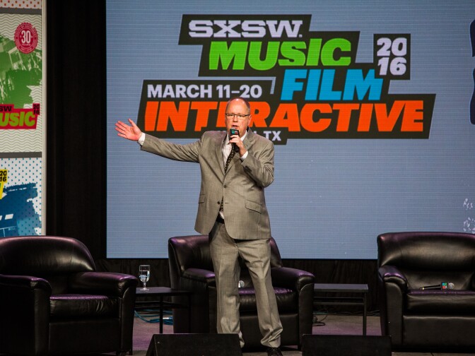 AUSTIN, TX - MARCH 16: SXSW co-founder Roland Swenson introduces first lady Michelle Obama at a panel discussion during SXSW on March 16, 2016 in Austin, Texas. Mrs. Obama was the keynote speaker at the event. This is the 30th anniversary of SXSW.  (Photo by Drew Anthony Smith/Getty Images)