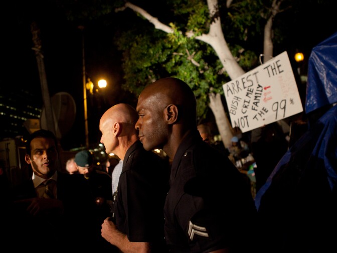 Spokesmen for the LAPD fielded questions from reporters outside the encampment on Sunday night.