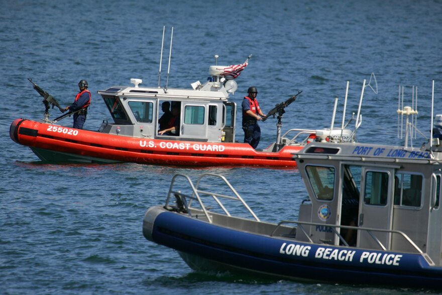 LONG BEACH, CA - JULY 31:  A U.S. Coast Guard gunboat and Long Beach Police patrol patrol the waters near where a news conference was being held by California Gov. Arnold Schwarzenegger and British Prime Minister Tony Blair at the Port of Long Beach July 31, 2006 in Long Beach, California. Schwarzenegger and Blair announced that California and the U.K. will collaborate on research, sharing information on combating global warming under a pact signed today. The two leaders attended a roundtable discussion with prominent CEOs and business leaders to share ideas on how business and government can work together to reduce greenhouse gas emissions and global climate change.  (Photo by David McNew/Getty Images)