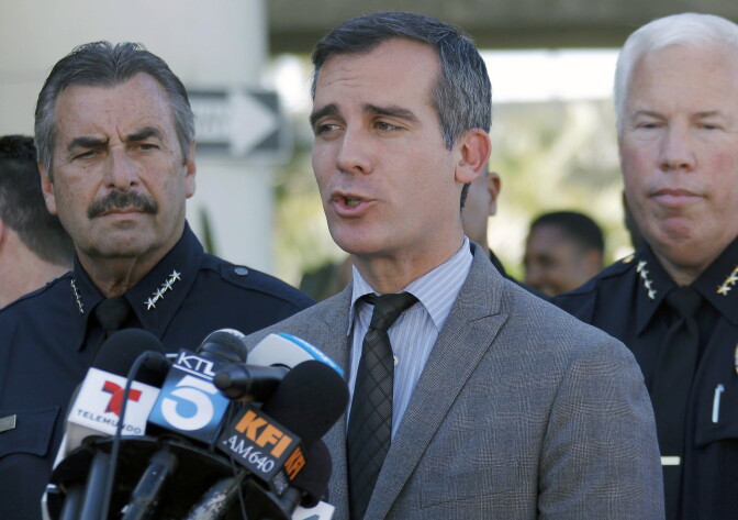 Los Angeles Police Chief Charlie Beck, left, joins Los Angeles Mayor Eric Garcetti, center, during a news conference at Los Angeles International Airport on Friday Nov. 1, 2013. A gunman armed with a semi-automatic rifle opened fire at Los Angeles International Airport on Friday, killing a Transportation Security Administration employee and wounding two other people. (AP Photo/Nick Ut)