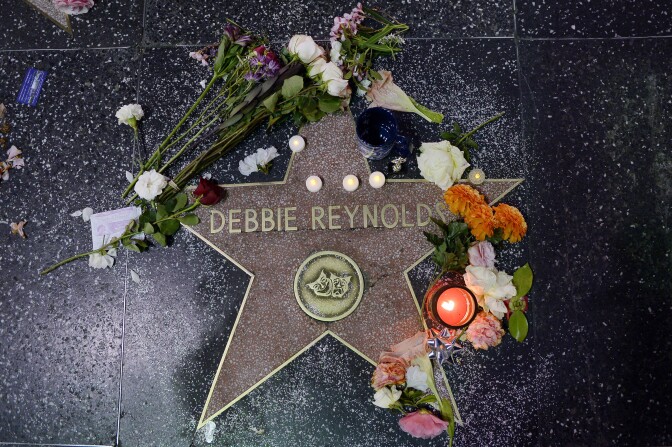 Flowers are placed Debbie Reynolds's live performance star on The Hollywood Walk of Fame on December 29, 2016 in Hollywood, California. Reynolds has two stars on The Hollywood Walk of Fame, one for live performance and another for film performance. 