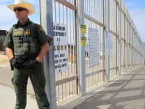 SAN DIEGO, CA - APRIL 29: A Border Patrol officer guards the entrance to Friendship Park, which has many restrictions, on April 29, 2018 in San Diego, California.  More than 300 immigrants, the remnants of a caravan of Central Americans that journeyed across Mexico to ask for asylum in the United States, have reached the border to apply for legal entry. (Photo by Bill Wechter/Getty Images)