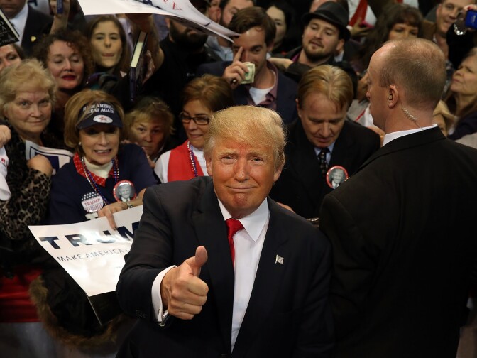 Republican presidential frontrunner Donald Trump pauses with supporters after speaking at the Mississippi Coast Coliseum on Jan. 2, 2016 in Biloxi, Mississippi. 