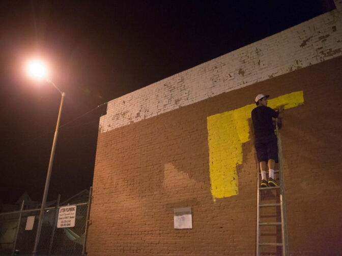 Graffiti Artist Edward Mompeller employs a fellow artist Julian, who tags as Naive, to help in creating a mural on an optical business in Highland Park.