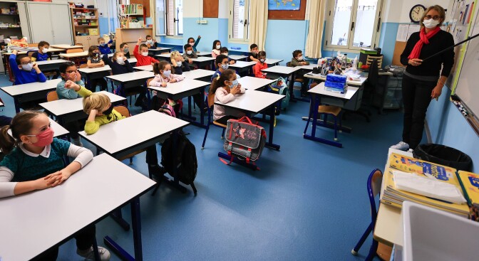 Students attend class wearing face masks in Antibes, France, on Nov. 2. At the end of October, France returned to a partial national lockdown to stem a surge in coronavirus cases. Meanwhile, schools remain open.