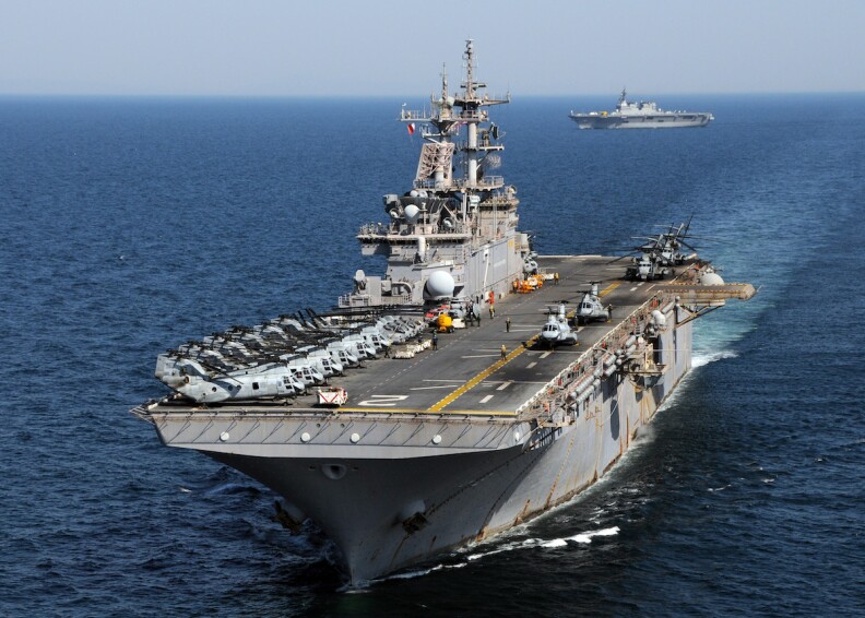 The assault ship USS Essex is seen at sea from the front.