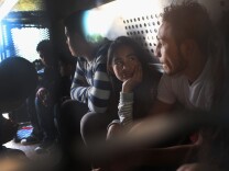 RIO GRANDE CITY, TX - DECEMBER 08:  Central American immigrants wait to be transported after turning themselves in to U.S. Border Patrol agents on December 8, 2015 near Rio Grande City, Texas. They had just illegally crossed the U.S.-Mexico border into Texas to seek asylum. The number of migrant families and unaccompanied minors has again surged in recent months, even as the total number of illegal crossings nationwide has gone down over the previous year.  (Photo by John Moore/Getty Images)