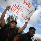 Leon Wheeler holds a sign that reads "We Support U.T. Austion" during a rally in front of the U.S. Supreme Court Supreme, on October 10, 2012 in Washington, DC. 