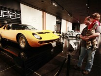 Steve Aubrey with his son, MacCorkle Aubrey look at a car in the Petersen Automotive Museum in Los Angeles Tuesday, April 26, 2011. The museum has begun auctioning off some of its classic cars.