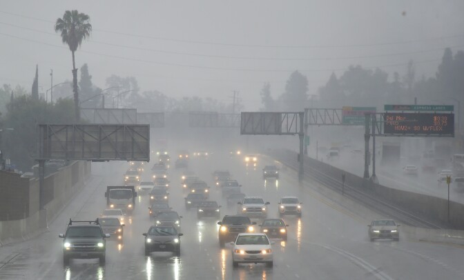 Commuters drive under heavy rainfall in Los Angeles, California on March 21, 2018
A slow-moving storm, billed as an "atmospheric river" began unleashing rain across southern California. Mandatory evacuations have been ordered by officials in Santa Barbara, Ventura and Los Angeles counties. / AFP PHOTO / Frederic J. Brown        (Photo credit should read FREDERIC J. BROWN/AFP/Getty Images)