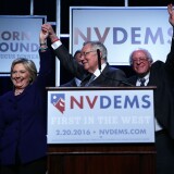 LAS VEGAS, NV - JANUARY 06:  Democratic Presidential candidates Hillary Clinton (L) and Sen. Bernie Sanders (I-VT) (R) on stage with Senate Minority Leader Harry Reid (D-NV) (2nd L) prior to the Battle Born/Battleground First in the West Caucus Dinner at the MGM Grand January 6, 2016 in Las Vegas, Nevada. The three candidates continue to campaign prior to the Nevada Democratic caucus, which will take place on February 20, 2016.  (Photo by Alex Wong/Getty Images)