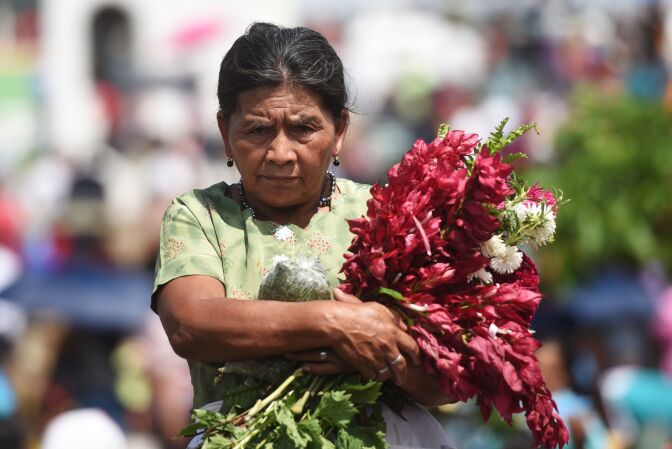 A woman visits the grave of a loved one in Panchimalco, El Salvador on November 2, 2016.