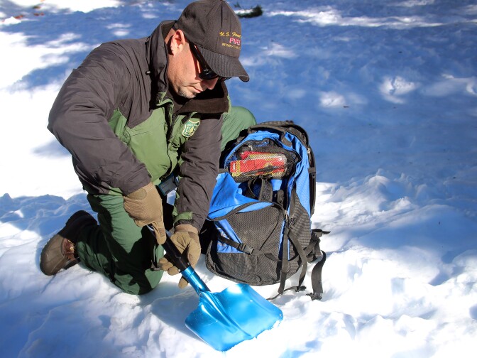 U.S. Forest Service fire information officer Nathan Judy digs a snow pit at Manker Flats, near Mt. Baldy. The pit walls will give a picture of the layers of snow that fell.