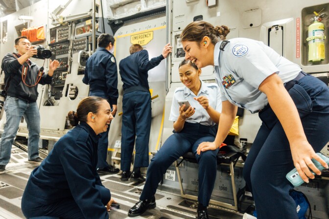(Left to right) Air Force Junior Reserve Officer Training Corps cadets Alma Del Muro, Sativa Dale and Madison Cote of Canyon Springs High School steady themselves during a bumpy part of the flight.