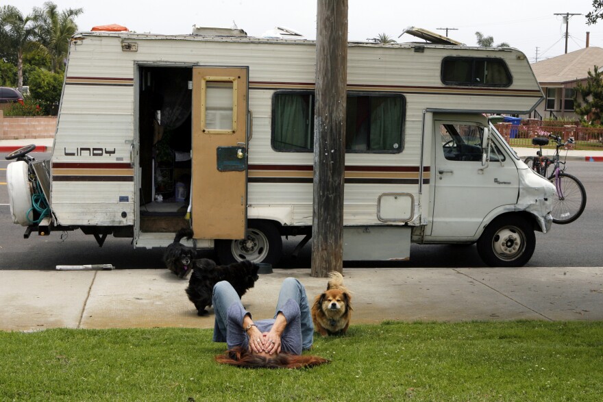 In this file photo, Darlene Knoll, 53, takes a moment to herself, Wednesday, June 4, 2008, in the Los Angeles neighborhood where she resides with five dogs in her battered 1978 motor home after losing her job and home five years earlier. Under an Assembly bill meant to protect homeless people, local governments could not punish people caught sleeping in cars. AB718 advanced to the Senate on Monday, June 1, 2015, with a 54-to-12 vote.
