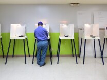 A voter casts his vote at a polling station in Pasadena, California, on November 4, 2014.