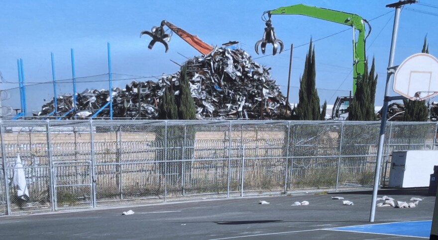 An industrial claw hovers above metal waste next door to Jordan High School in Watts.