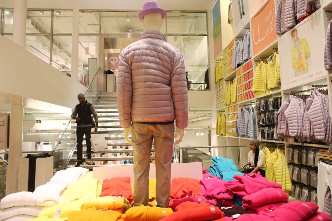 NEW YORK, NY - FEBRUARY 13:  A man carries a shopping bag in a Uniqlo store in Manhattan on February 13, 2013 in New York City. The Commerce Department reported that retail sales were only up slightly in January following tax increases and high gas prices.  (Photo by Mario Tama/Getty Images)