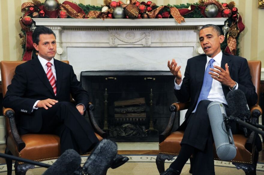 US President Barack Obama speaks tyo the press with President-elect Enrique Pena Nieto of Mexico during a bilateral meeting in the Oval Office at the White House in Washington on November 27, 2012. Pena Nieto, a member of the Institutional Revolutionary Party (PRI), takes office on December 1, replacing Felipe Calderon from the conservative National Action Party (PAN), five months after his election victory.