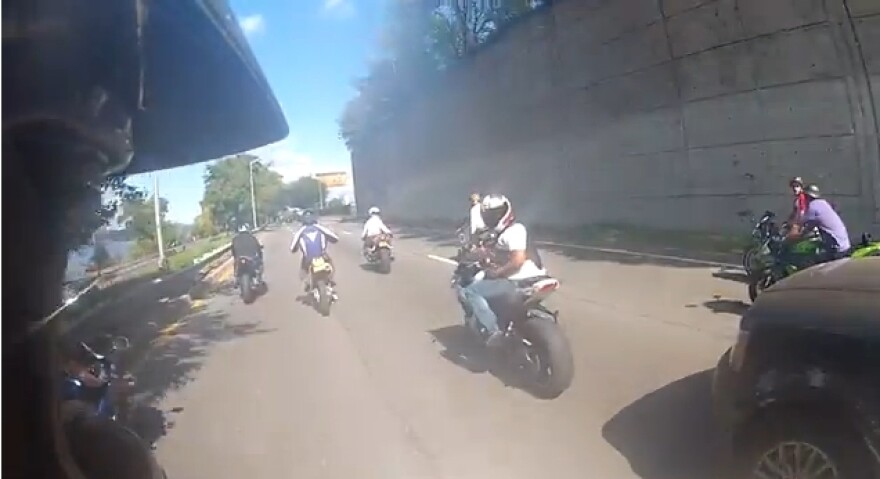 Screenshot of the motorcyclist right before it hits the SUV