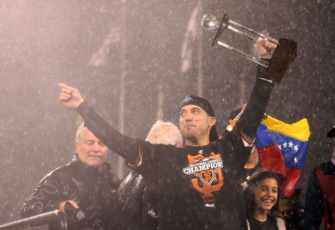 Marco Scutaro #19 of the San Francisco Giants holds up the MVP trophy after the Giants defeat the St. Louis Cardinals 9-0 in Game Seven of the National League Championship Series at AT&T Park on October 22, 2012 in San Francisco, California. 