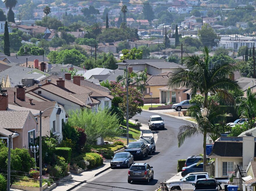 A vehicle drives through a residential neighborhood in Los Angeles.