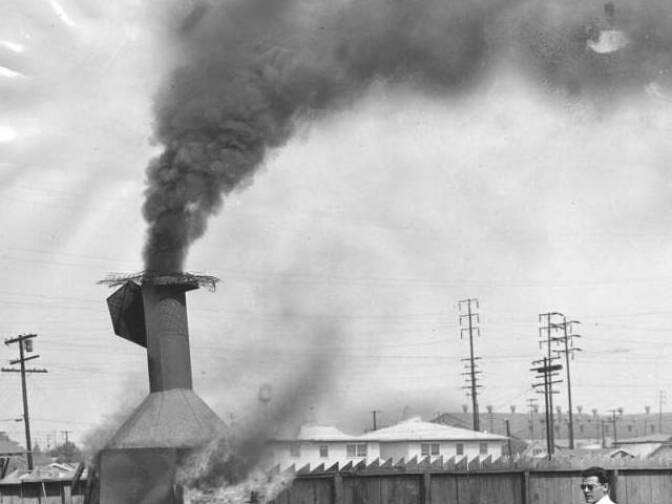 Outdoor view of a residential incinerator burning trash. All refuse burning in Los Angeles will end October 1 when Air Pollution Control District's ban on residential incinerators becomes effective. Photo dated July 1, 1957.