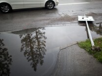A street sign on Coldwater Avenue in Studio City is knocked over on Friday, Feb. 28 after an overnight rainstorm in Southern California.