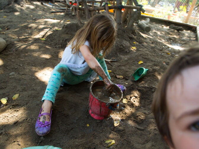 A preschool student at La Canada's Child Educational Center plays with mud. Jordan Young, a neuroscientist,  emphasizes that associations between gender and color, or gender and specific activities aren’t hardwired in the baby’s brain – the physical and social environment we give to kids builds them up