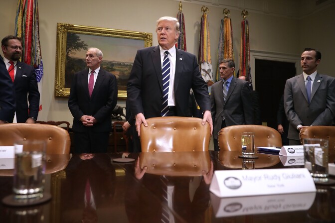 WASHINGTON, DC - JANUARY 31:  U.S. President Donald Trump (C) arrives for a meeting with Homeland Security Secretary John Kelly (2nd L), National Security Advisor Michael Flynn, White House Government Initiatives Director Reed Cordish and other government cyber security experts in the Roosevelt Room at the White House January 31, 2017 in Washington, DC. Citing the hack of computers at the Democratic National Committee by Russia, Trump said that the private and public sectors must do more to prevent and protect against cyber attacks.  (Photo by Chip Somodevilla/Getty Images)
