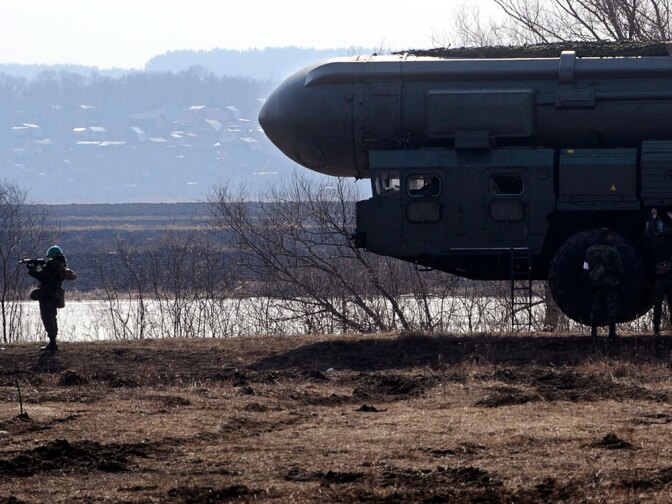 A Russian soldier guards a model of a Topol Intercontinental ballistic missile during a training session near Moscow in April.  The new START treaty aims to limit U.S. and Russian nuclear warheads and missiles.
