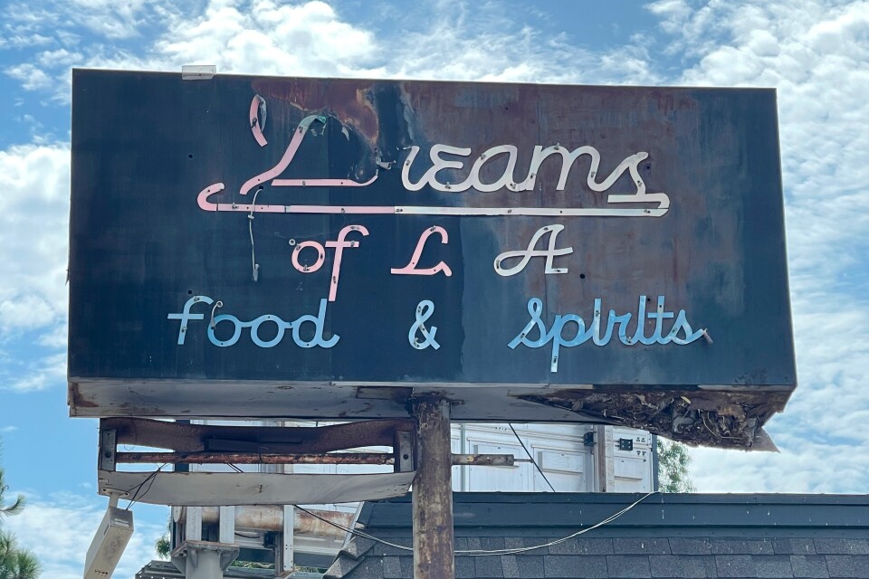 A rusted sign reads Dreams of L.A. Food & Spirits.