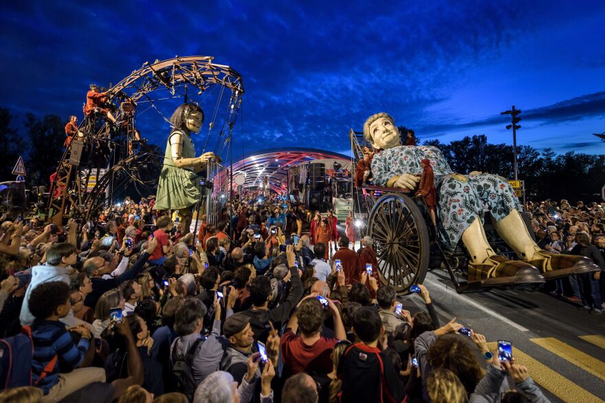 Animated marionettes called 'The Little Girl Giant' and 'The Grandmother Giant' by French theater company Royal de Luxe parade through the streets of Geneva, Switzerland on September 29, 2017.