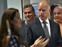 Governor Jerry Brown enters the The Mars Curiosity rover environmental monitoring station on August 22, 2012 at NASA's Jet Propulsion Laboratory. 