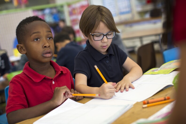 Kindergarteners Bryden Musgrove, left, and Gemma Gomez take part in a writing exercise in Mandarin at Eugene Field Elementary, a dual immersion school in Pasadena, on Thursday morning, May 28, 2015. Kindergarten students at the school spend 90 percent of their day learning subject areas in the Mandarin language.