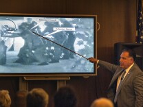 Orange County District Attorney Tony Rackauckas shows the jury an image of Fullerton police trying to subdue Kelly Thomas at the Fullerton Transportation Center on July 5, 2011 during the trial of former Fullerton officers Manuel Ramos and Jay Cicinelli on Monday, Dec. 2, 2013 in Santa Ana, Calif.  Rackauckas told jurors that Ramos and Cicinelli were responsible for the death of 37-year-old Kelly Thomas in July 2011. Thomas, whose family says was schizophrenic, died five days after the violent confrontation with six officers who responded to a call about a man jiggling car door handles in a transit center parking lot. Ramos is charged with second-degree murder and involuntary manslaughter. Cicinelli is charged with to involuntary manslaughter and use of excessive force. Defense attorneys are seeking to introduce evidence that Thomas had a history of violence and suffered from psychotic episodes due to prolonged methamphetamine abuse.