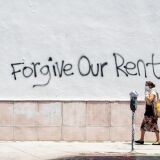 A woman wearing a mask walks past a wall bearing a graffiti asking for rent forgiveness on La Brea Ave on National May Day amid the Covid-19 pandemic,  May 1, 2020, in Los Angeles, California. - Several cities and states, including California, have passed executive orders prohibiting eviction of tenants affected by the coronavirus crisis.
But when the lockdown lifts, the moratorium will end. And tenants will have to pay their back-rent or move out. (Photo by VALERIE MACON / AFP) (Photo by VALERIE MACON/AFP via Getty Images)