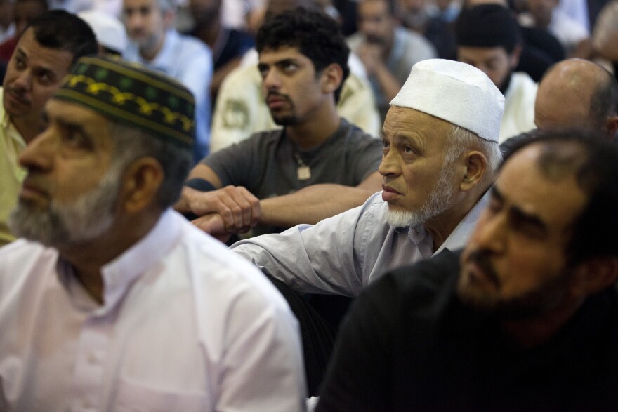 Abdul Rahman Mayet listens to a summon during Friday afternoon prayers at the King Fahad Mosque in Culver City.