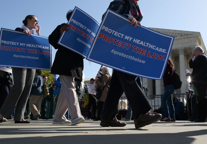 People march in favor of the Patient Protection and Affordable Care Act in front of the U.S. Supreme Court on March 26, 2012 in Washington, DC. 