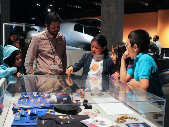 Children from Dr. Theodore T. Alexander Science Center School look at items that American Astronaut Garrett Reisman used during Endeavour's SIS-123 mission.
