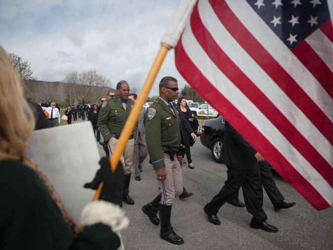 California Highway Patrol officers make their way to a funeral for Det. Jeremiah MacKay in San Bernardino on Feb. 21, 2013.