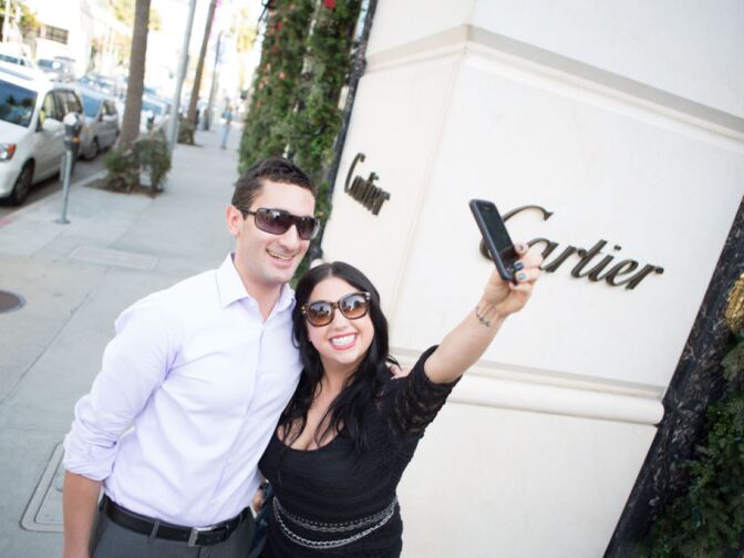 Dani Kinnischtzke poses with Adam Swart, the founder of Crowds On Demand. Swart created the event on Rodeo Drive on Decmeber 11th, 2012 to get photos for his ad campaign in China.