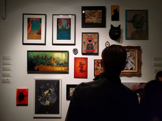 Patrons walk through Think Tank Art Gallery for the opening reception of the Cat Art Show, on display through Sunday, March 27, 2016.