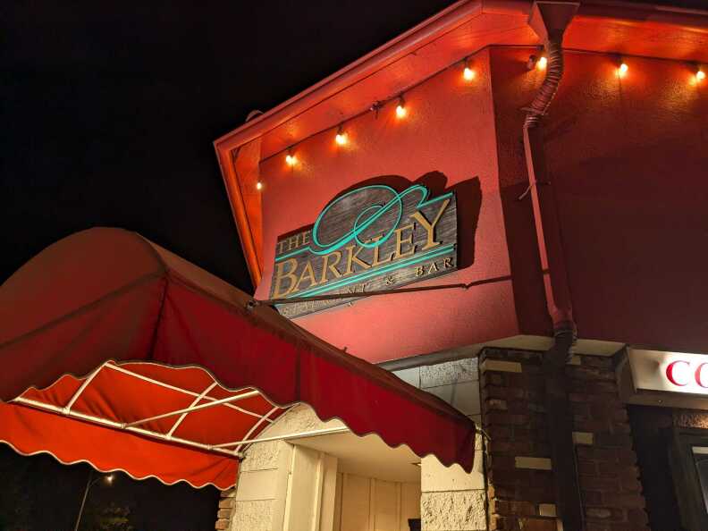 A sign outside of a building that says "The Barkley"