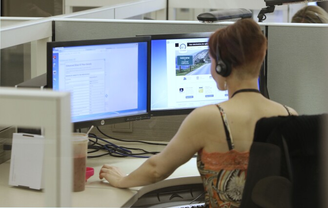 Gina Macaluso, an employee of  Covered California, the state's new health care exchange, provides health insurance at the  newly opened call center in Rancho Cordova, Calif., Tuesday, Oct. 1, 2013. 